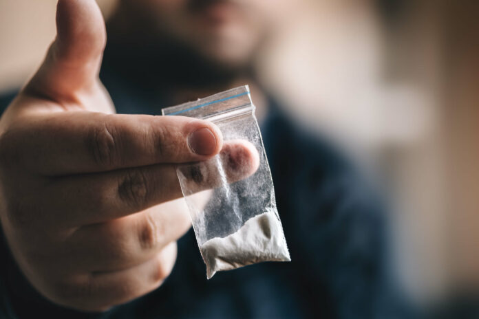 closeup-of-a-hand-holding-a-small-bag-of-cocaine.2012170755550